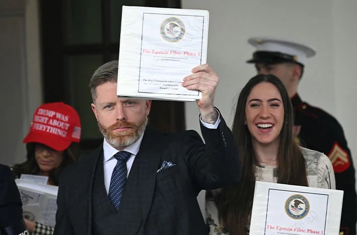 Conservative political commentator Rogan O'Handley, also known as DC Draino, social media content creator Chaya Raichik, and conservative political commentator Liz Wheeler hold up binders titled 