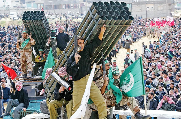 Thousands of Hamas members with mock weapons rally in Gaza.