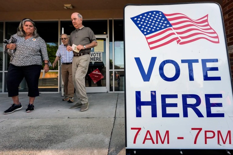 Voters depart an election center.