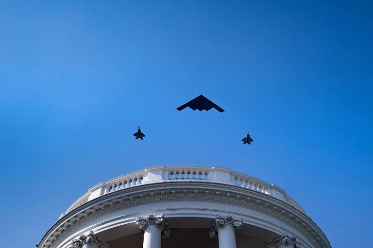 A B-2 Spirit stealth bomber escorted by 2 F-35 Lightning II stealth fighters.