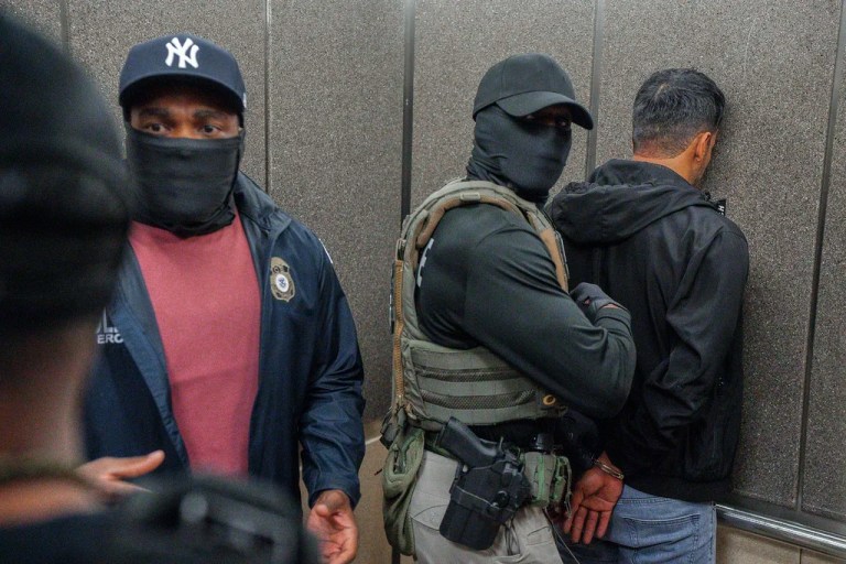 Immigration and Customs Enforcement agents escort a detained immigrant into an elevator after he exited an immigration courtroom, Tuesday, June 17, 2025, in New York.