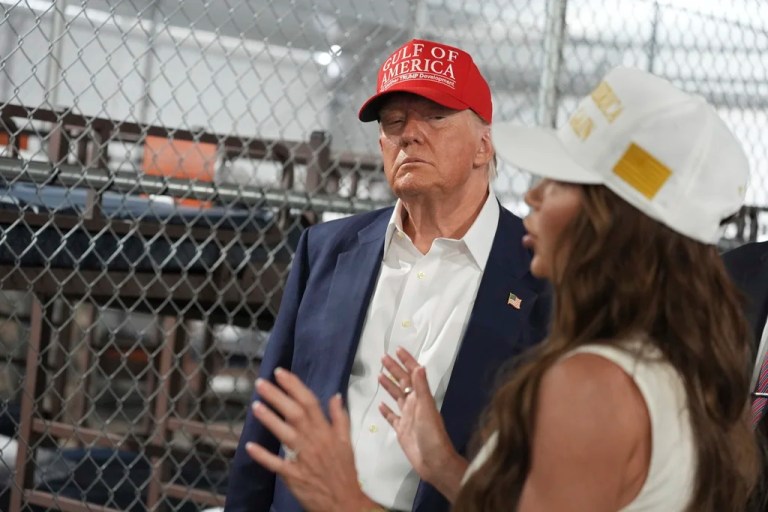 President Donald Trump listens to Homeland Security Secretary Kristi Noem, as they and others tour 