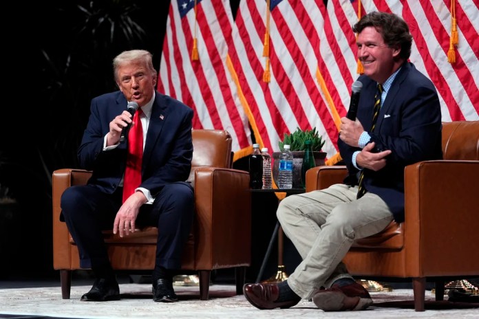 Republican presidential nominee former President Donald Trump speaks with Tucker Carlson.