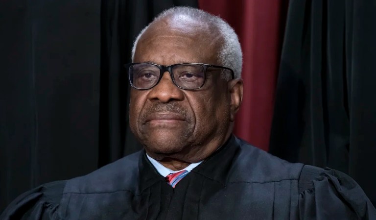 Associate Justice Clarence Thomas joins other members of the Supreme Court as they pose for a new group portrait, at the Supreme Court building in Washington, Oct. 7, 2022. Thomas is absent from the court Monday with no explanation. The 75-year-old Thomas also is not participating remotely in arguments, as justices sometimes do when they are ill or otherwise can’t be there in person. Chief Justice John Roberts announced Thomas’ absence, saying that his colleague would still participate in the day’s cases, based on the briefs and the transcripts of the arguments.
