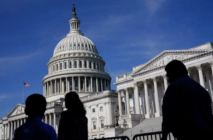 People walk outside the Capitol building in Washington.