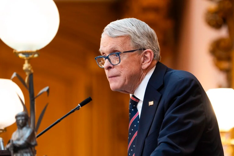Gov. Mike DeWine (R-OH) speaks into a microphone.