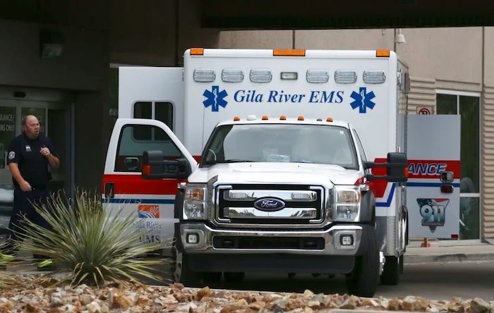 An ambulance parks at the emergency room entrance at Banner Estrella Medical Center.
