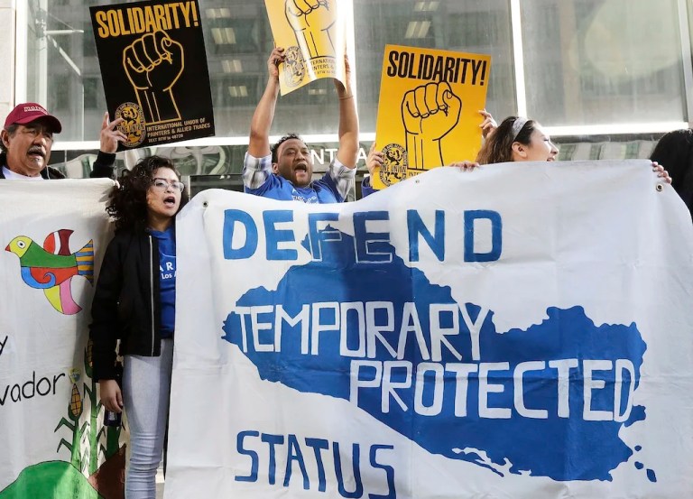 FILE - Supporters of temporary protected status immigrants hold signs and cheer at a rally before a conference announcing a lawsuit against the Trump administration over its decision to end a program letting immigrants live and work legally in the United States outside of a federal courthouse in San Francisco, March 12, 2018. (AP Photo/Jeff Chiu, File)