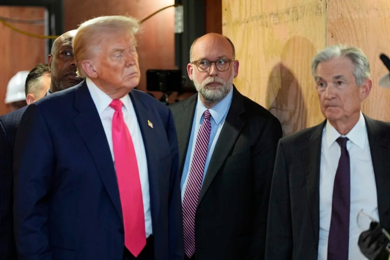 Office of Management and Budget Director Russell Vought, President Donald Trump, and Federal Reserve Chairman Jerome Powell stand next to one another.