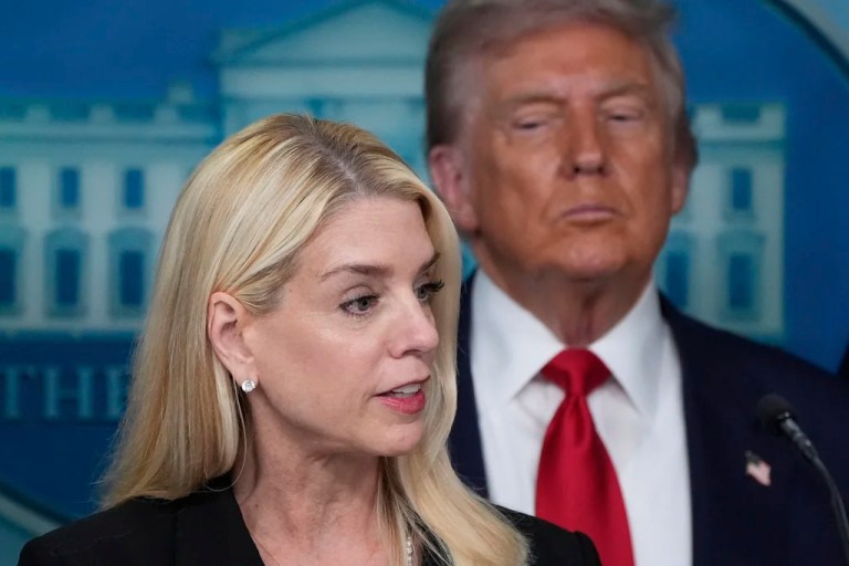 Attorney General Pam Bondi speaks with reporters in the James Brady Press Briefing Room, as President Donald Trump listens.