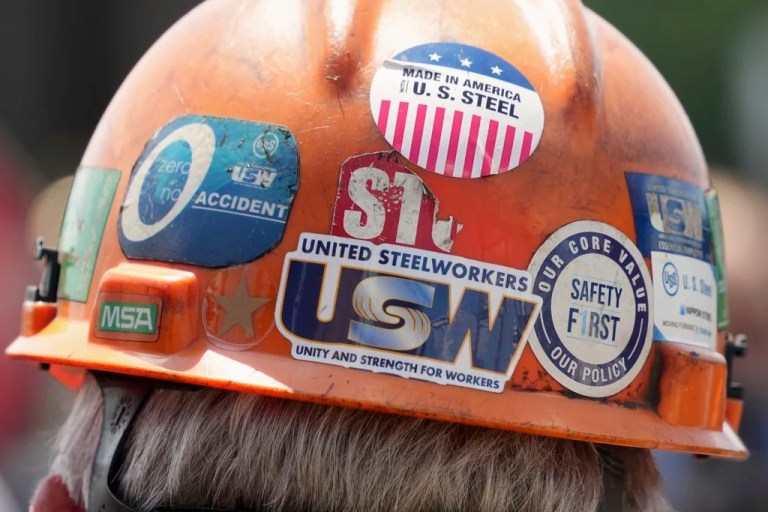 The back of a safety helmet worn by a steelworker.