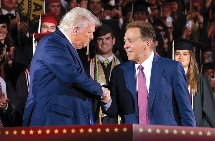 President Donald Trump shakes hands with former Alabama football coach Nick Saban, May 1, 2025, in Tuscaloosa, Alabama. Trump created a presidential commission on college sports, of which Saban and billionaire Texas Tech booster Cody Campbell are members. (Anna Moneymaker/Getty Images)