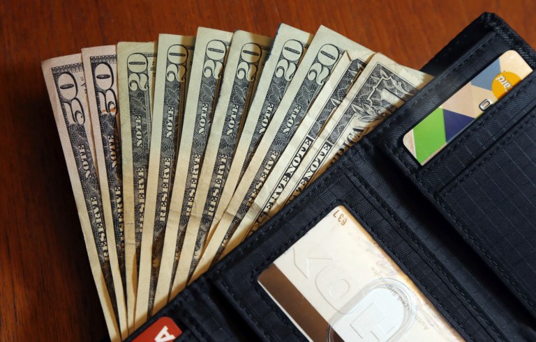 Cash fanned out from a wallet.