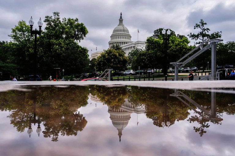 The U.S. Capitol is reflected in a puddle outside of the Rayburn House Office Building, Wednesday, July 16, 2025, on Capitol Hill in Washington.