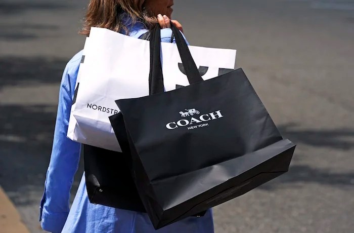 A shopper carries bags in Pittsburgh on Monday, June 3, 2024. On Friday, June 14, 2024, the University of Michigan releases its preliminary reading of consumer sentiment for June.