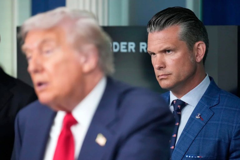 Defense Secretary Pete Hegseth listens as President Donald Trump speaks with reporters in the James Brady Press Briefing Room at the White House, Monday, Aug. 11, 2025, in Washington.