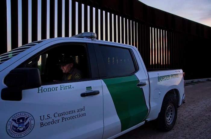 A border patrol agent works by a section of the border wall, Wednesday, June 18, 2025,