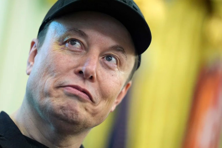 Elon Musk listens as President Donald Trump speaks during a news conference in the Oval Office of the White House, Friday, May 30, 2025, in Washington.