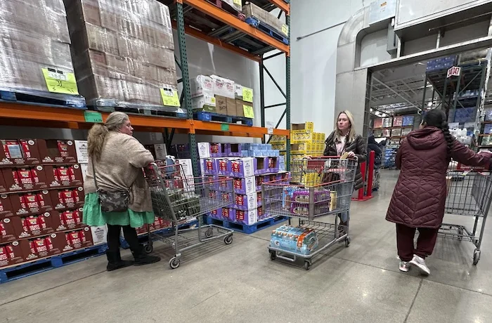 Shoppers guide their carts through the milk display in a Costco warehouse on Jan. 23, 2025.