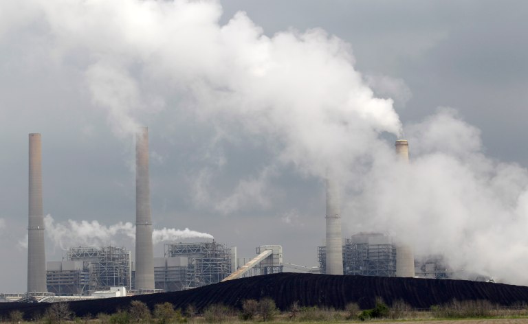 This Wednesday, March 16, 2011, picture shows piles of coal at NRG Energy's W.A. Parish Electric Generating Station in Thompsons, Texas. The plant, which operates natural gas and coal-fired units, is one of the largest power plants in the United States. If Earth overheats, can it be artificially cooled? Should the effort begin now? Who would decide? The very idea of 