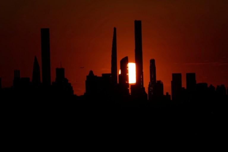 The New York City skyline is seen as the sun sets.