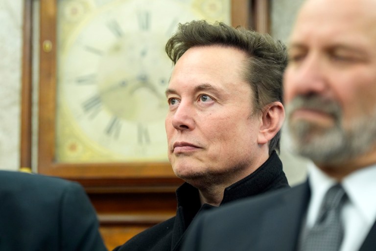 Tesla CEO Elon Musk stands in the Oval Office.