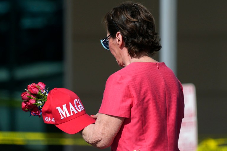A well-wisher arrives at the national headquarters of Turning Point USA shown after the shooting death of Charlie Kirk, the co-founder and CEO of the organization, during a Utah college event, Wednesday, Sept. 10, 2025, in Phoenix.