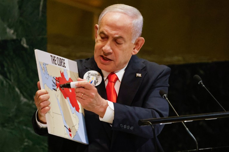 Israeli Prime Minister Benjamin Netanyahu holds a map while speaking at the 80th session of the United Nations General Assembly.