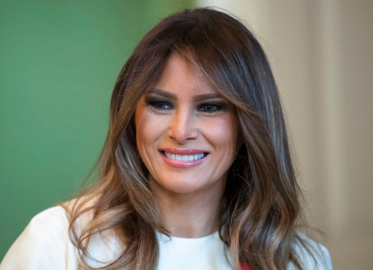 In this Monday, Nov. 27, 2017 file photo, First lady Melania Trump smiles as she visits with children in the East Room of the White House in Washington. The First Lady honored 200 years of holiday traditions at the White House. Melania Trump's cranberry topiary trees may have left some of her critics seeing red, but they turned out to be a Christmas hit - one of several new ideas the Trumps introduced this holiday season. (AP Photo/Carolyn Kaster, File)