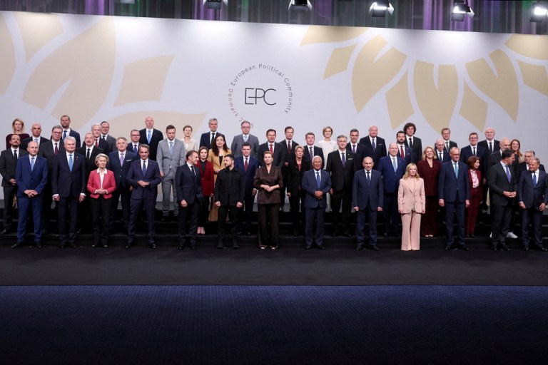 Heads of state pose for a family photo.