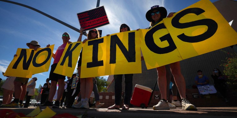 A group of protesters spell out 