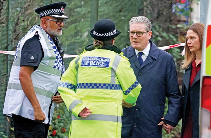 British Prime Minister Keir Starmer talks to police outside Manchester’s Heaton Park Hebrew Congregation synagogue, Oct. 3, 2025. (PHIL NOBLE / AFP / Getty Images)