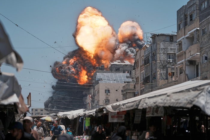Flames and thick smoke erupt from an Israeli airstrike in Gaza City.