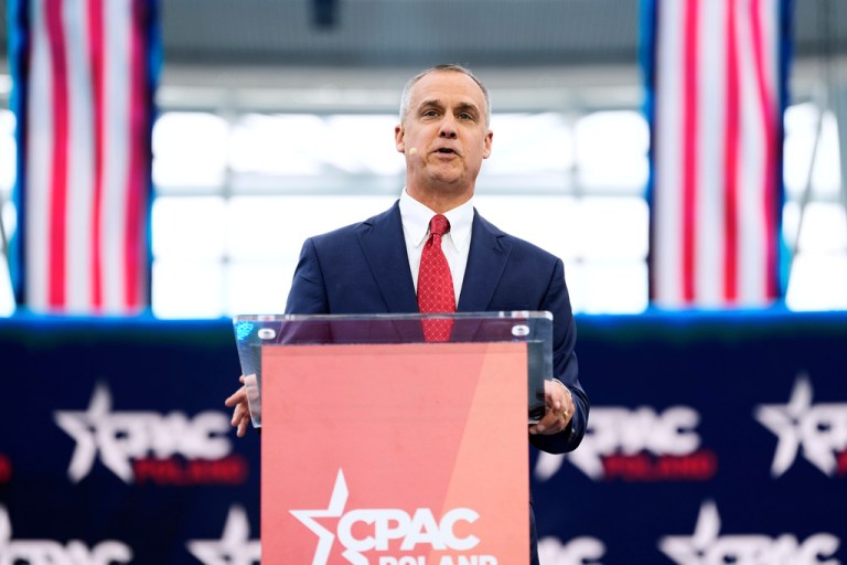 Lewandowski speaks behind behind a podium.