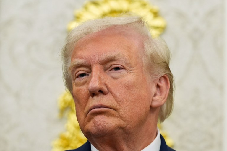 President Donald Trump listens during an event in the Oval Office.