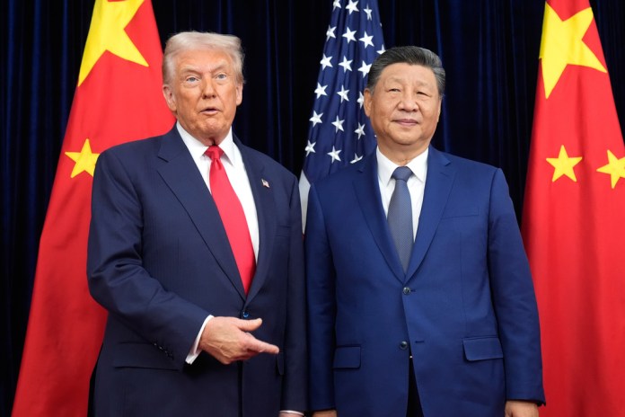 Trump stands next to Chinese President Xi Jinping.