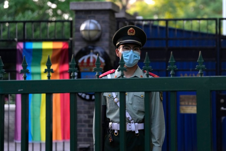 A Chinese paramilitary policemen stands guard outside the Swedish embassy.