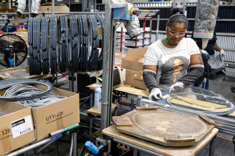An employee pieces together components on an assembly line at GE Appliances global headquarters, Wednesday, Aug 13, 2025, in Louisville, Ky
