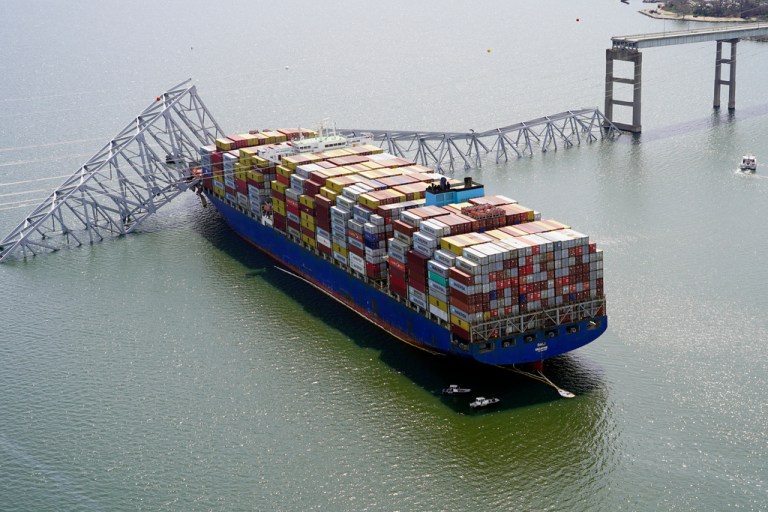 The cargo ship Dali is stuck under part of the structure of the Francis Scott Key Bridge after the ship hit the bridge.