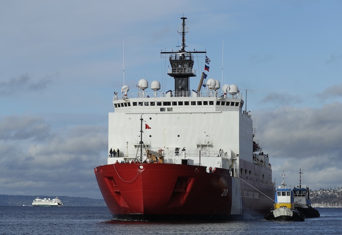 Tugboats help the U.S. Coast Guard Cutter Healy icebreaker into its home port.