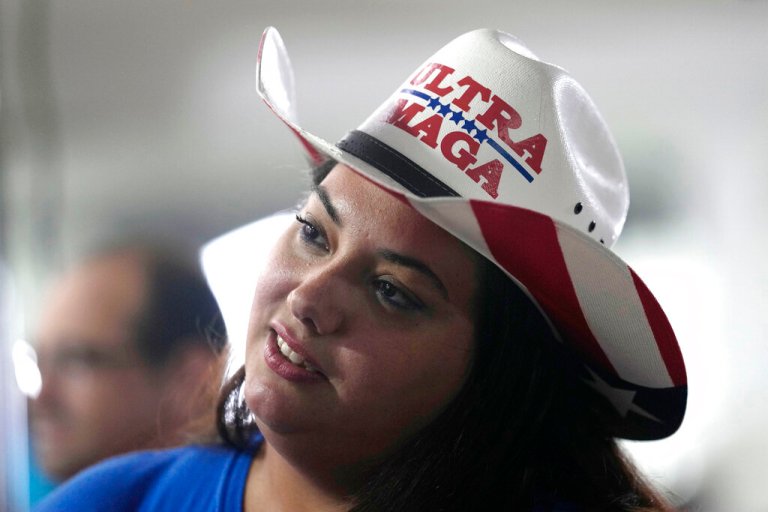 Beatriz Morales wears a hat reading Ultra MAGA as she attends a campaign rally for Republican Governor Ron DeSantis.