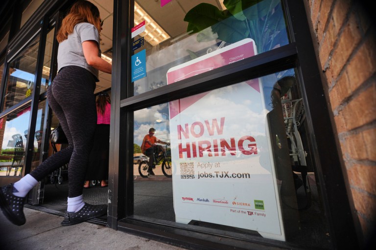 A sign announces hiring.