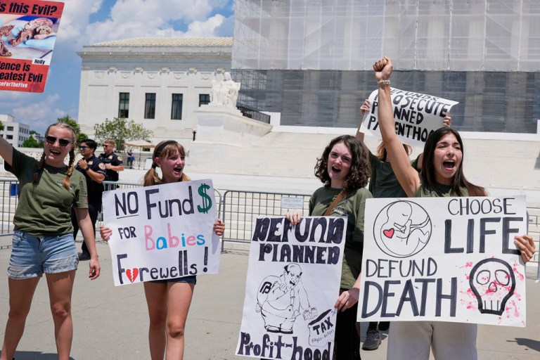 Abortion-rights protesters rally outside of the Supreme Court.