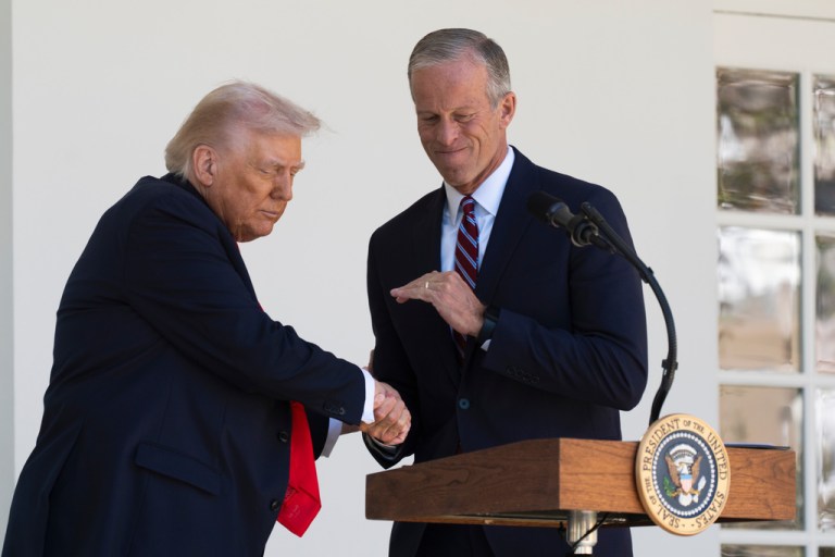 President Donald Trump shakes hands with Senate Majority Leader John Thune, (R-SD).
