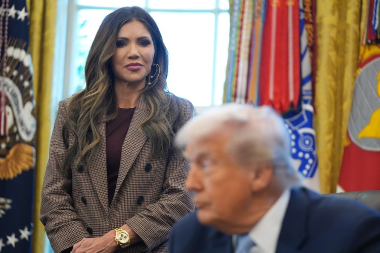 Homeland Security Secretary Kristi Noem listens as President Donald Trump speaks during a meeting in the Oval Office.