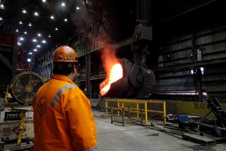 In this June 28, 2018 photo, senior melt operator Randy Feltmeyer watches a giant ladle as it backs away after pouring its contents of red-hot iron into a vessel in the basic oxygen furnace as part of the process of producing steel at the U.S. Steel Granite City Works facility in Granite City, Ill.