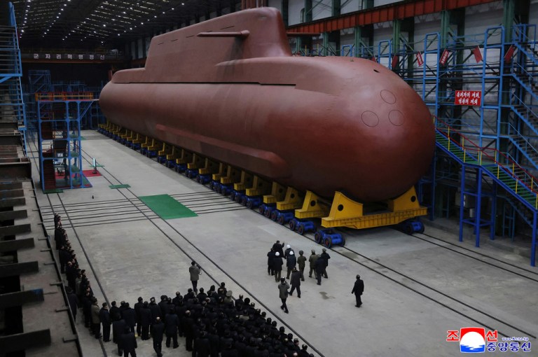 North Korean leader Kim Jong Un inspects a nuclear-powered submarine under construction.