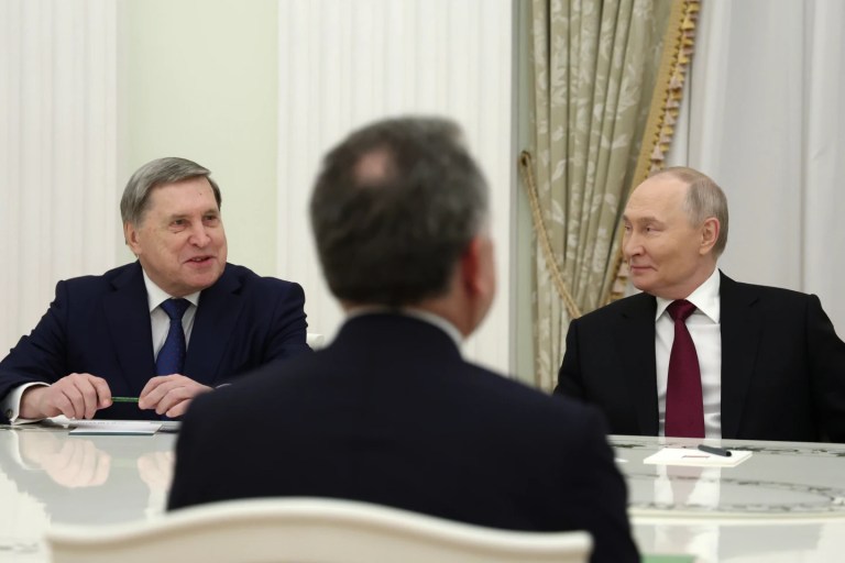 Russian President Vladimir Putin, right, and Russian Presidential foreign policy adviser Yuri Ushakov, left, attend talks with U.S. special envoy Steve Witkoff, back to camera, at the Senate Palace of the Kremlin in Moscow, Russia, Tuesday, Dec. 2, 2025. (Alexander Kazakov, Sputnik, Kremlin Pool Photo via AP)