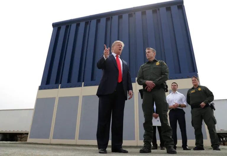 President Donald Trump speaks during a tours as he reviews border wall prototypes, Tuesday, March 13, 2018, in San Diego, as Rodney Scott, the Border Patrol's San Diego sector chief, listens.