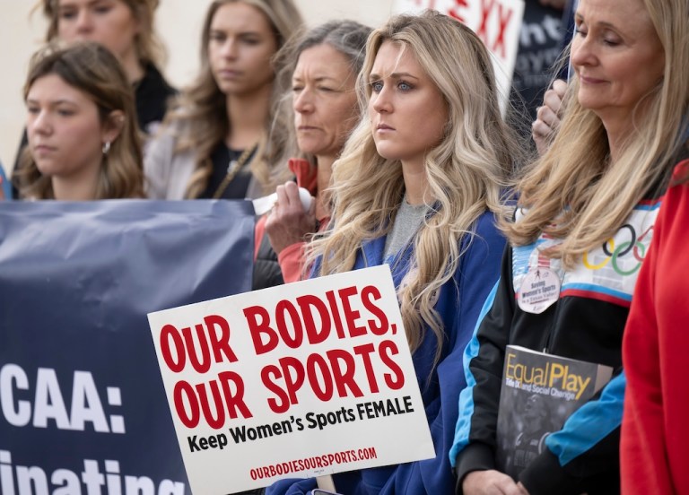 Former University of Kentucky swimmer Riley Gaines, second from right, stands during a rally, Jan. 12, 2023, outside of the NCAA Convention in San Antonio.